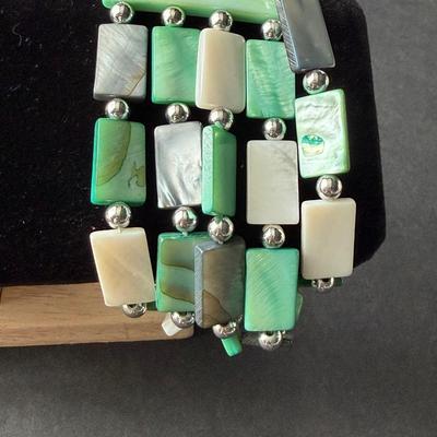 Multi strand green rectangular and white shell type bracelet