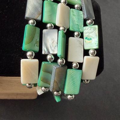 Multi strand green rectangular and white shell type bracelet