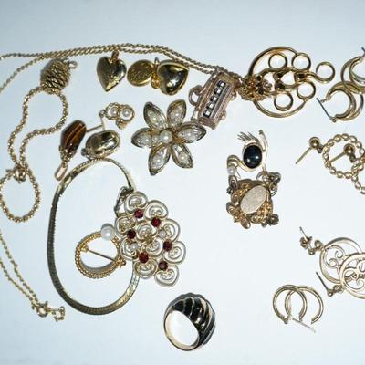 Sale Photo Thumbnail #300: a mix of gold filled and brass 
charms of heart lockets and trolly car are brass
pin of garnet and seed pearls in 10 kt gold filled missing seed pearl in the center, '
18kt gold filled ring with onyx size 6-6 /2 
gold swan pin with onyx and pearl 14kt gol