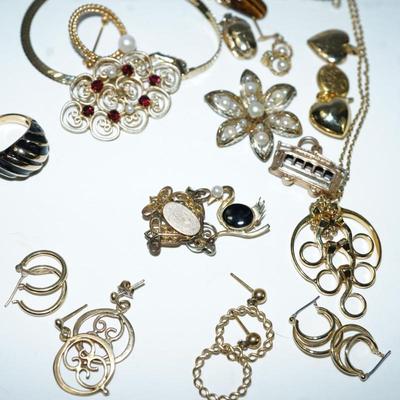 Sale Photo Thumbnail #301: a mix of gold filled and brass 
charms of heart lockets and trolly car are brass
pin of garnet and seed pearls in 10 kt gold filled missing seed pearl in the center, '
18kt gold filled ring with onyx size 6-6 /2 
gold swan pin with onyx and pearl 14kt gol