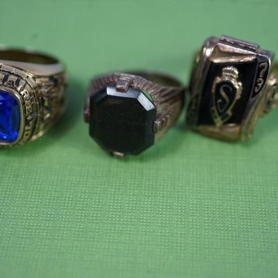 Sale Photo Thumbnail #309: two class rings, onyx and sterling?
white metal and brass watch fobs
eagle pin signed
two avaiator pins -sterling
merchant marine pin - sterling'
brass cuff link of roman coin repro 
rose gold plate golf or card pencil
Alva sun burst pendant 
other...