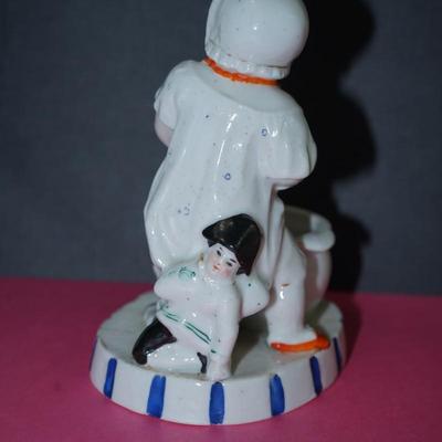 Sale Photo Thumbnail #364: Circa 1910 glazed porcelain match keep, the base of the figurine is a stike for the match, 
Little novelty of a baby about to sit on the commode. Its doll behind him. 
Height 5" 
the base measiures 4" by 3 1/4"
Good condition, slight wear to the base. and
