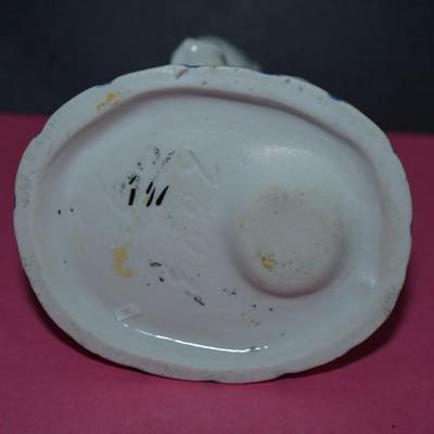 Sale Photo Thumbnail #366: Circa 1910 glazed porcelain match keep, the base of the figurine is a stike for the match, 
Little novelty of a baby about to sit on the commode. Its doll behind him. 
Height 5" 
the base measiures 4" by 3 1/4"
Good condition, slight wear to the base. and