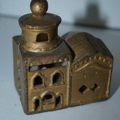 Sale Photo Thumbnail #389: pair of vintage still banks. 
dog 4 1/4" 
the smaller building is 3" 
there is alot of paint loss on the dog . there is a slot behind his head to drop the coins
to get the coins out there is a screw, No coins are in the bank
The building is in good condit