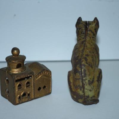 Sale Photo Thumbnail #388: pair of vintage still banks. 
dog 4 1/4" 
the smaller building is 3" 
there is alot of paint loss on the dog . there is a slot behind his head to drop the coins
to get the coins out there is a screw, No coins are in the bank
The building is in good condit
