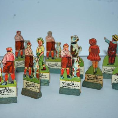 Sale Photo Thumbnail #403: grouping of 11 Kennedy Dairy carboard cut outs of children and advertising of Kennedy Dairy of Madison, WI 
I would guess these are from the 30's . In good condition and good color except for one the face is missing. 
Otherwise these are a perfect project