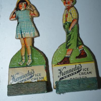 Sale Photo Thumbnail #399: grouping of 11 Kennedy Dairy carboard cut outs of children and advertising of Kennedy Dairy of Madison, WI 
I would guess these are from the 30's . In good condition and good color except for one the face is missing. 
Otherwise these are a perfect project