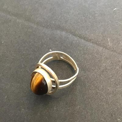 Sale Photo Thumbnail #38: Very nice silver 925 Israel ring with polished tiger eye stone. Please see attached photos.