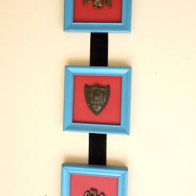 Pair of Identical Framed Metal Emblems on Hanging Ribbon