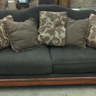 Fabric overstuffed sofa, green w/wood trim.