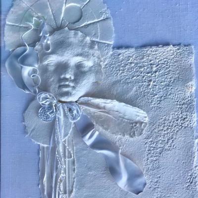 Numbered, delicate white framed art of child in a bonnet made of paper.