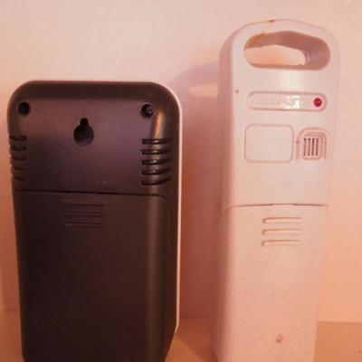 Lot 38: A Pair of Indoor Battery Weather Clocks with Remotes