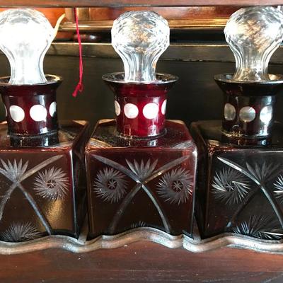 Lot 131-Antique Mahogany Tantalus with Ruby Cut to Clear Bottles