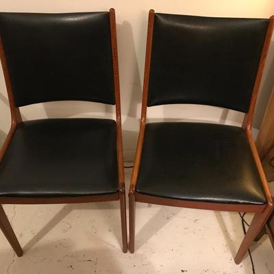 Lot 100- Pair of MCM Teak and Black Vinyl Side Chairs