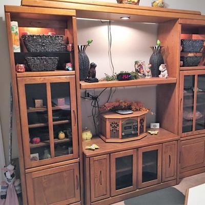 Oak entertainment console loaded with decor and throw-back audio system