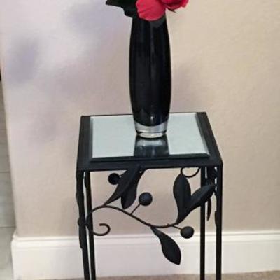 Small accent table with vase and floral arrangement