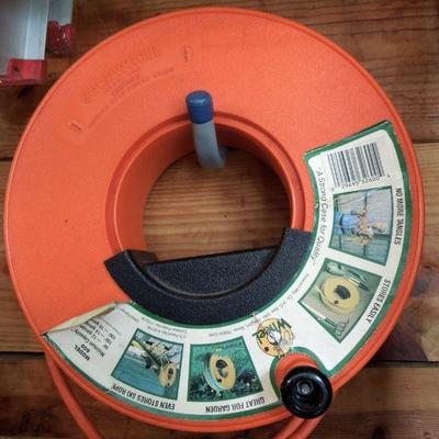 Lot 252: Four Ladders and 3 Extension Cords on Reels