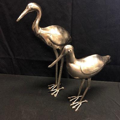 Silver colored metal bird sculptures 