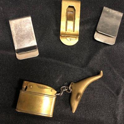 Lot 19 - Money clips and brass lighter 
