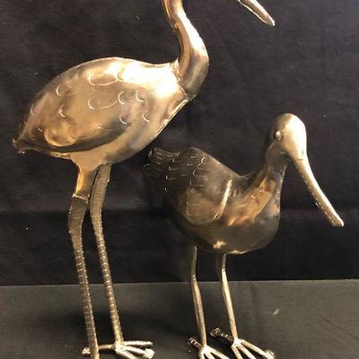 Silver colored metal bird sculptures 