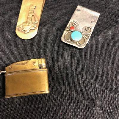 Lot 19 - Money clips and brass lighter 