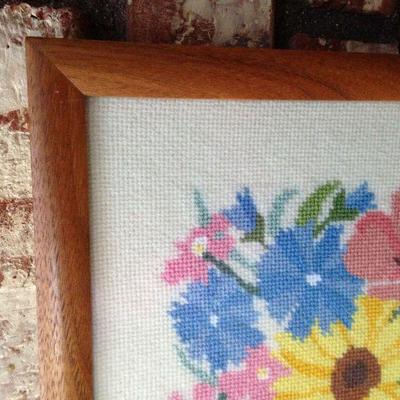 Cross-stitch in lovely pastel colors (blues, pinks, yellow, purples, greens).