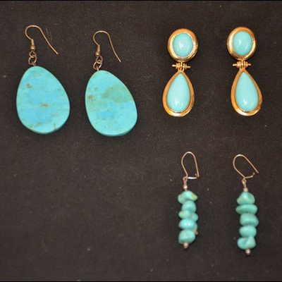 three pairs of turquoise dangle earrings, one is in a 14K gold setting