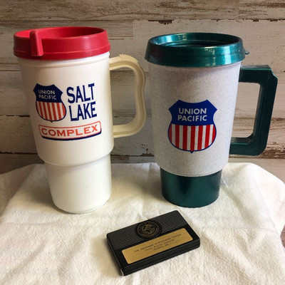 Lot 204 2 plastic Union Pacific Mugs and a tape measure