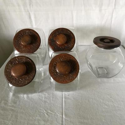 Lot 32 - Five Glass and Wood Canisters