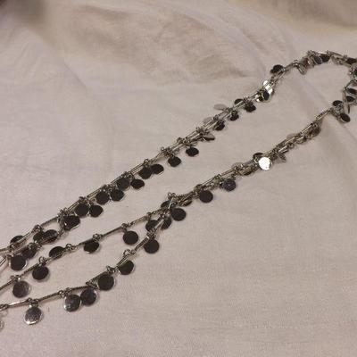 Silvertone long strand  with shiny silver discs