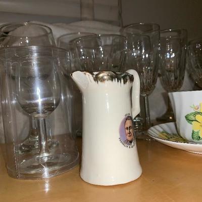 Assortment of Items Wine Glasses Teacup And Saucer