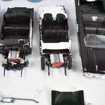 Model Cars in Various Stages of Completion, with Lots of Pieces and Parts