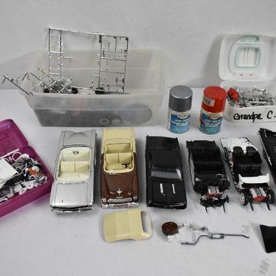 Model Cars in Various Stages of Completion, with Lots of Pieces and Parts