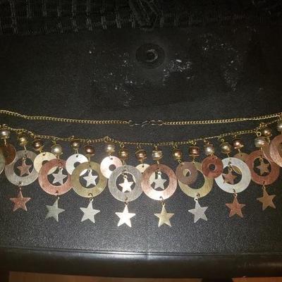 Gold tone star and bell necklace 