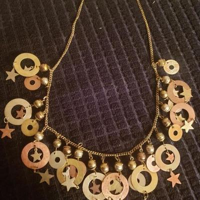 Gold tone star and bell necklace 