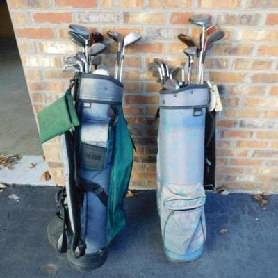 Two Sets of Gold Clubs and Bags