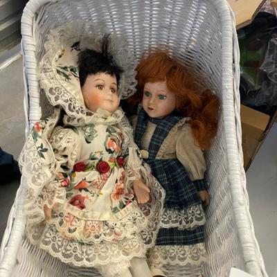 Lot 143 Porcelain dolls (3) in wicker carriage