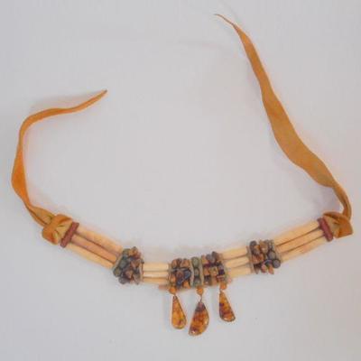 Lot 2055 - Bone and Amber choker with suede