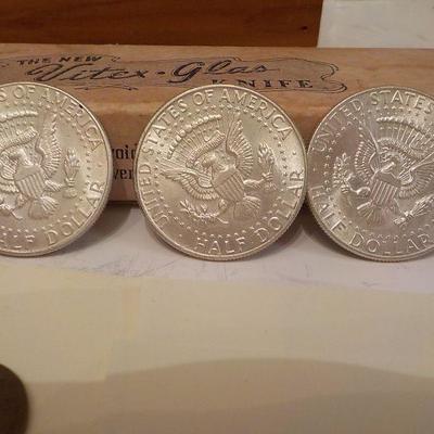 3- 1964 Kennedy half dollar coins.