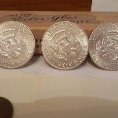 3- 1964 Kennedy half dollar coins.