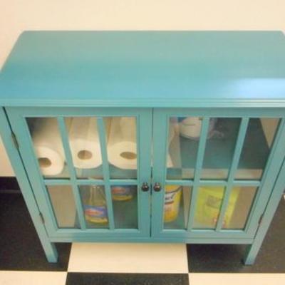 Lot 106 - Blue Wooden Cabinet with Glass Pane Doors + Cleaning Products