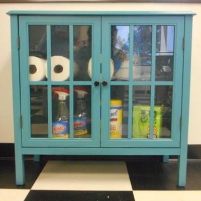 Lot 106 - Blue Wooden Cabinet with Glass Pane Doors + Cleaning Products