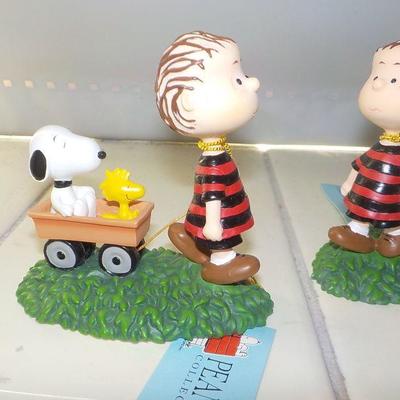 Charlie Brown and Snoopy collector figurines. (2)