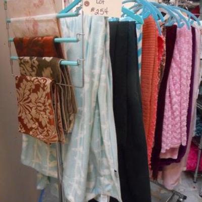 Lot 254 - Rolling Clothes Rack Full of Blankets + One Black Sheet