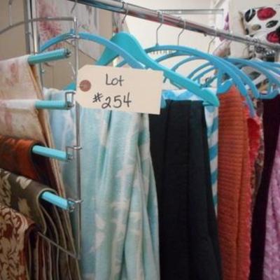 Lot 254 - Rolling Clothes Rack Full of Blankets + One Black Sheet