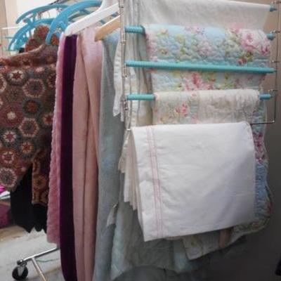 Lot 254 - Rolling Clothes Rack Full of Blankets + One Black Sheet
