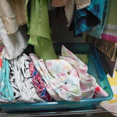 Lot 822 - Wide Assortment of Table Cloths  + Runners and Place Mats + Wheeled Rack 