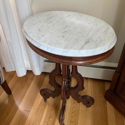 Antique Victorian walnut oval marble top table.