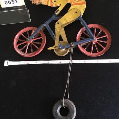 Antique painted Tin Bicyclist - Rides on a wire across the room.