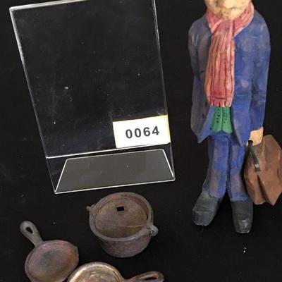 3 toy miniature cast iron skillets and a carved doctor or carpetbagger - you decide :o)